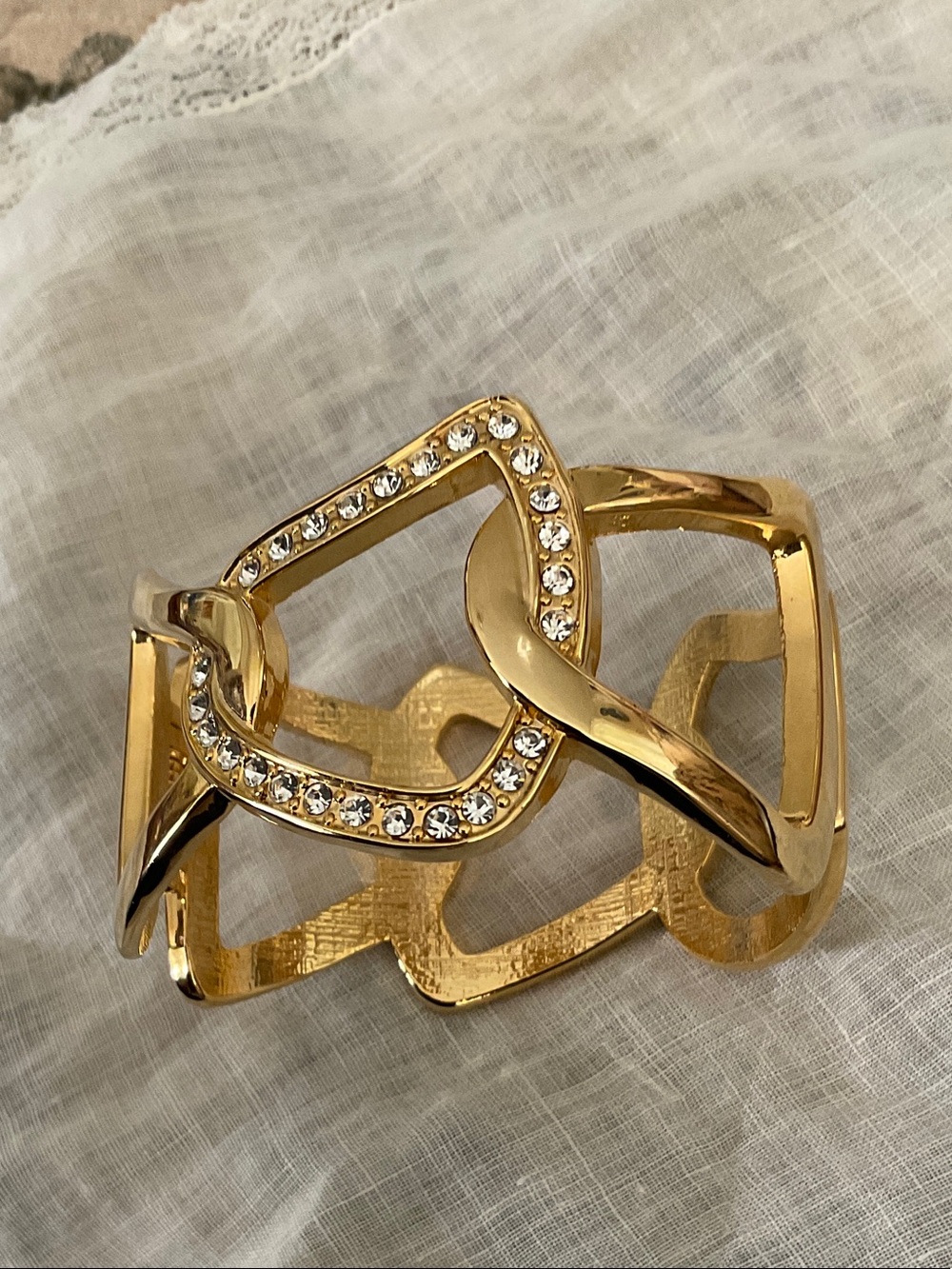 GOLD PLATED FASHION BANGLE WITH ACCENT ZIRCONIA CHIPS. HINGED TO OPEN- OS.
